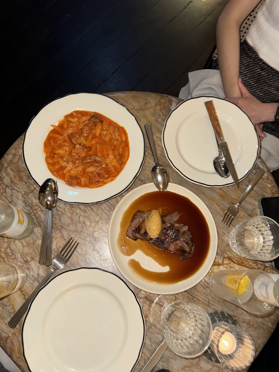 Shared Italian dishes on a marble table at Palazzo Salato