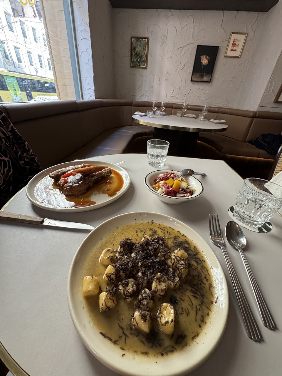 Pasta and plated dishes on a corner table at Palazzo Salato